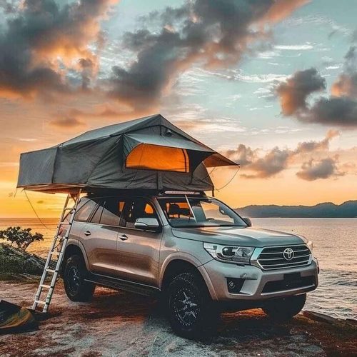 Soft top long roof tent-12 The setting sun fills the sea, camping in a roof tent